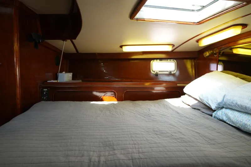 Peggy Lee Yacht Photos Pics Cozy cabin interior of 1984 Irwin 52 Cutter Ketch with bed and porthole.