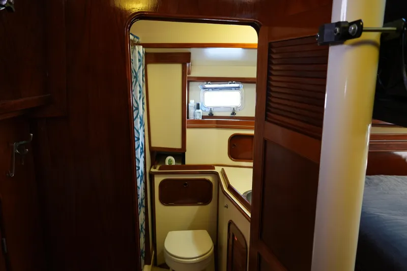 Peggy Lee Yacht Photos Pics 1984 Irwin 52 Cutter Ketch bathroom with wooden interior and compact design.