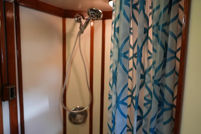 Peggy Lee Yacht Photos Pics Shower area in 1984 Irwin 52 Cutter Ketch with patterned curtain and wooden accents.