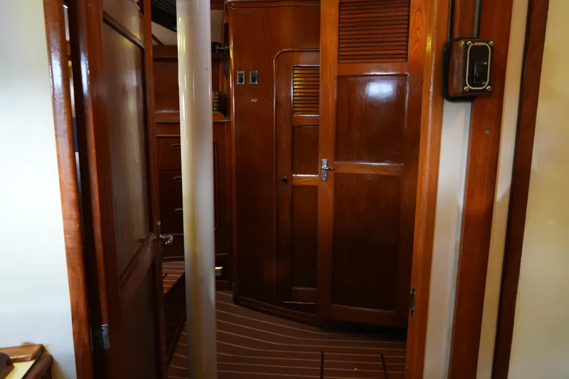 Peggy Lee Yacht Photos Pics Interior of 1984 Irwin 52 Cutter Ketch, featuring wooden cabinetry and doors.