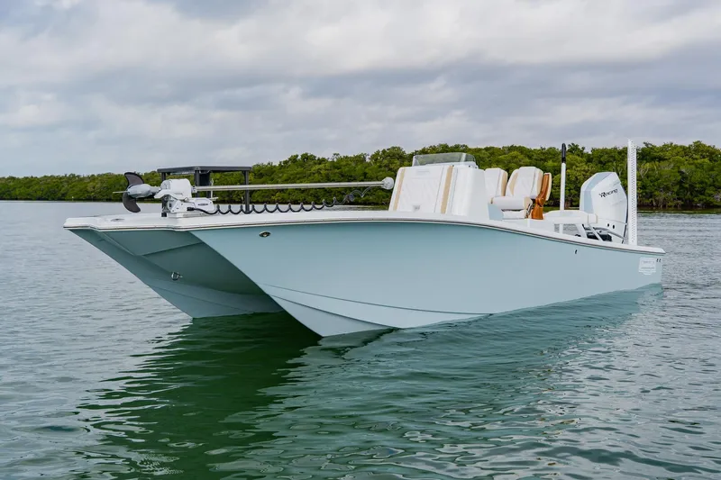  Yacht Photos Pics 2026 Broadwater 25 Bay Cat boat on calm water, featuring sleek design and modern amenities.