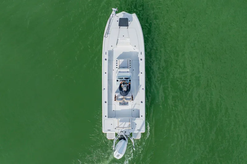  Yacht Photos Pics Aerial view of 2026 Broadwater 25 Bay Cat boat on green water.