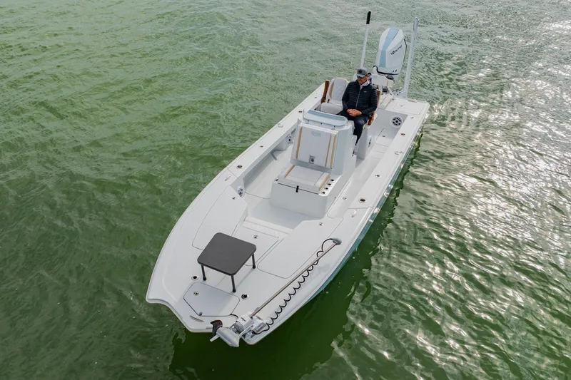  Yacht Photos Pics 2026 Broadwater 25 Bay Cat boat on calm green water, aerial view.