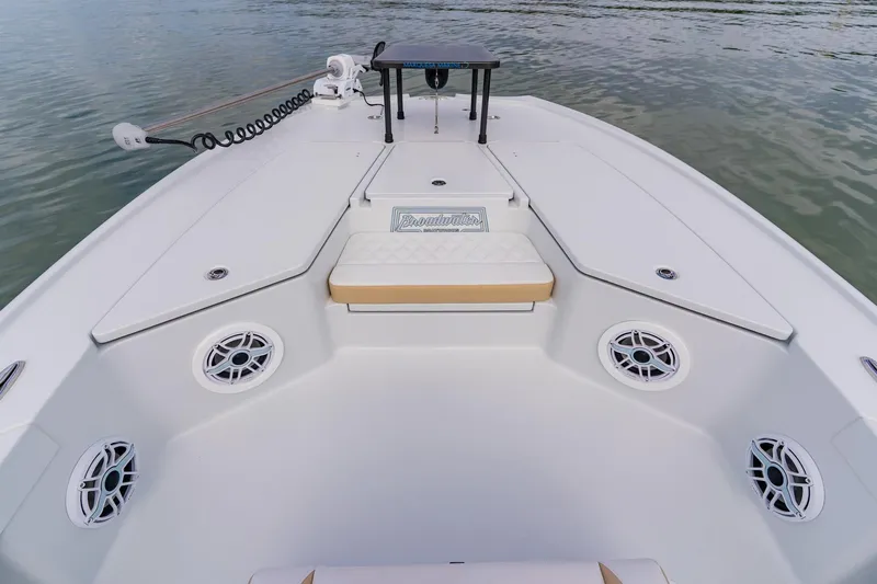  Yacht Photos Pics 2026 Broadwater 25 Bay Cat boat interior with seating and speakers on calm water.