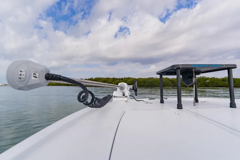 Yacht Photos Pics 2026 Broadwater 25 Bay Cat boat on calm water with clear sky.
