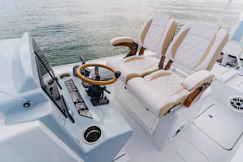 Yacht Photos Pics Luxurious helm seating on 2026 Broadwater 25 Bay Cat boat, featuring modern controls and design.