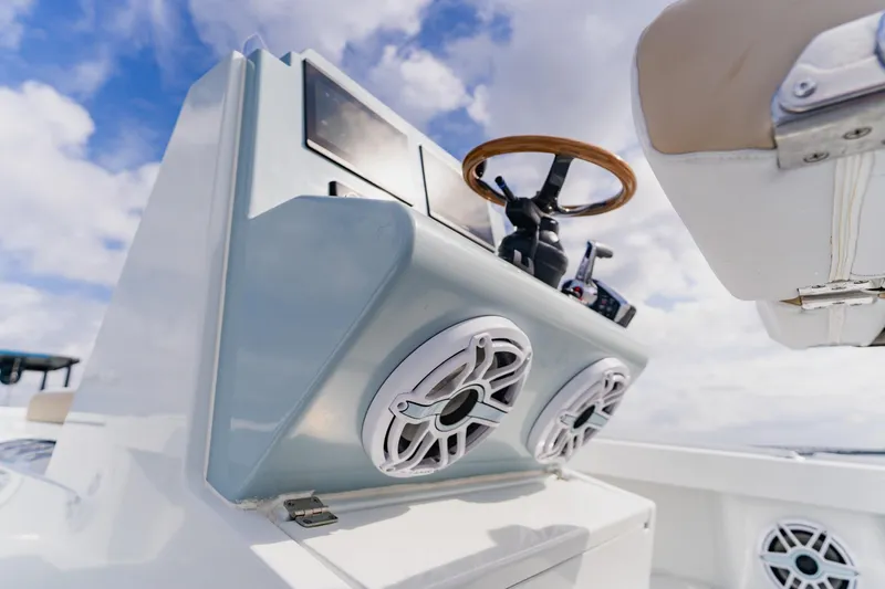  Yacht Photos Pics 2026 Broadwater 25 Bay Cat boat dashboard with speakers and steering wheel.