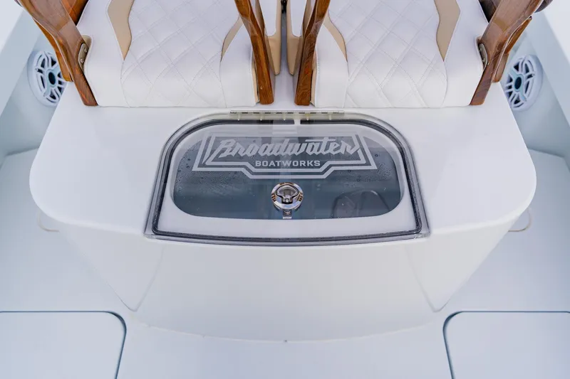  Yacht Photos Pics 2026 Broadwater 25 Bay Cat boat interior with elegant seating and branded compartment.