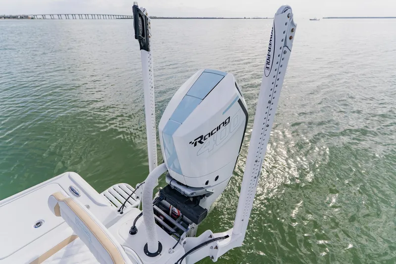  Yacht Photos Pics 2026 Broadwater 25 Bay Cat boat with powerful outboard motor on calm water.