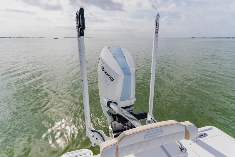  Yacht Photos Pics 2026 Broadwater 25 Bay Cat boat with powerful outboard motor on calm water.