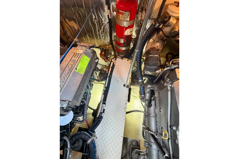  Yacht Photos Pics Engine room of 2007 Cruisers Yachts 370 Express with visible Yanmar engine and fire extinguisher.