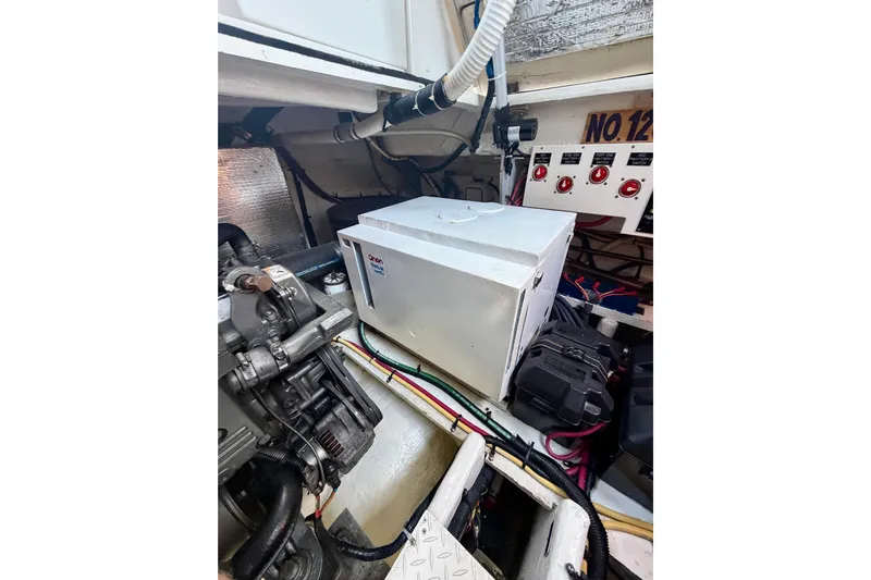  Yacht Photos Pics Engine room of 2007 Cruisers Yachts 370 Express with generator and control panel.