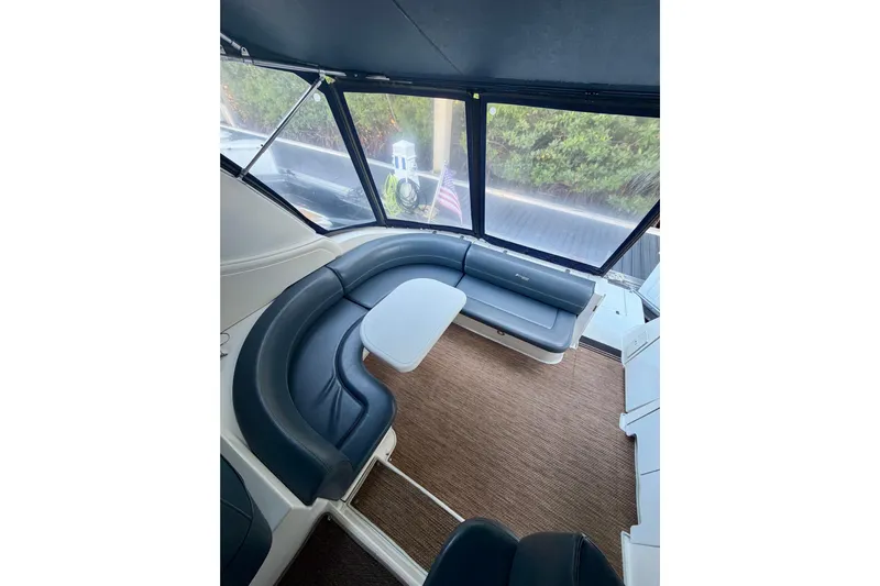  Yacht Photos Pics 2007 Cruisers Yachts 370 Express interior with curved seating and table.