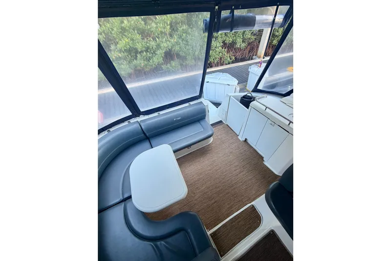  Yacht Photos Pics 2007 Cruisers Yachts 370 Express interior with seating and table, featuring modern design.