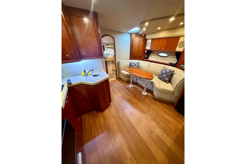  Yacht Photos Pics Interior of 2007 Cruisers Yachts 370 Express with wood flooring and cozy seating area.