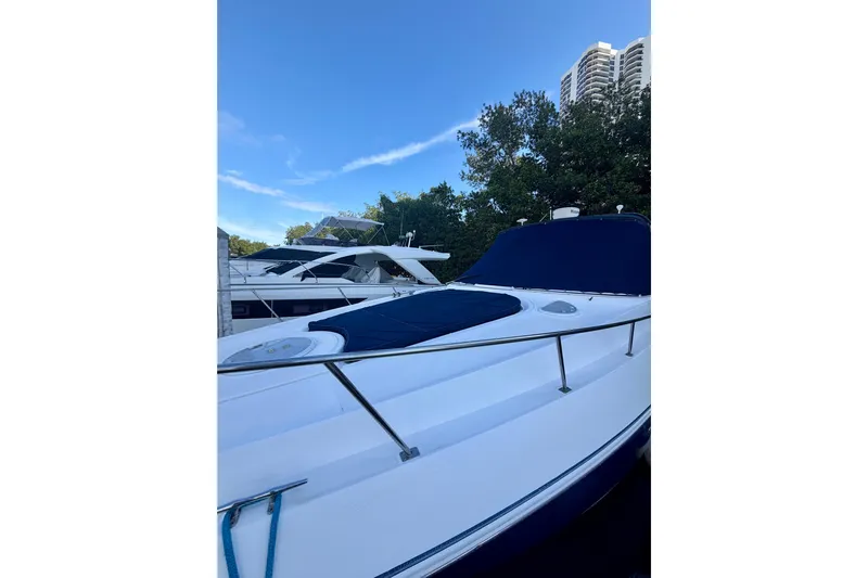  Yacht Photos Pics 2007 Cruisers Yachts 370 Express docked, featuring sleek design and blue canopy.