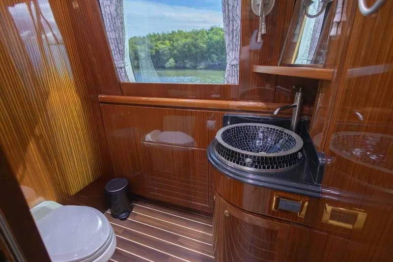 Okie Dokie Yacht Photos Pics Luxurious 2009 Hargrave Enclosed Bridge yacht bathroom with elegant wood finish and modern fixtures.