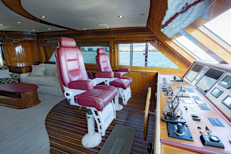 Okie Dokie Yacht Photos Pics Luxurious 2009 Hargrave Enclosed Bridge yacht interior with red captain chairs and control panel.