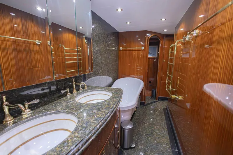 Okie Dokie Yacht Photos Pics Luxurious bathroom in 2009 Hargrave Enclosed Bridge yacht with dual sinks and elegant wood paneling.