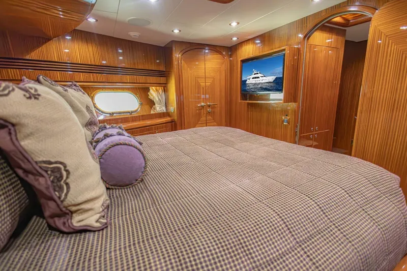 Okie Dokie Yacht Photos Pics Luxurious 2009 Hargrave Enclosed Bridge yacht bedroom with elegant wood paneling and plush bedding.