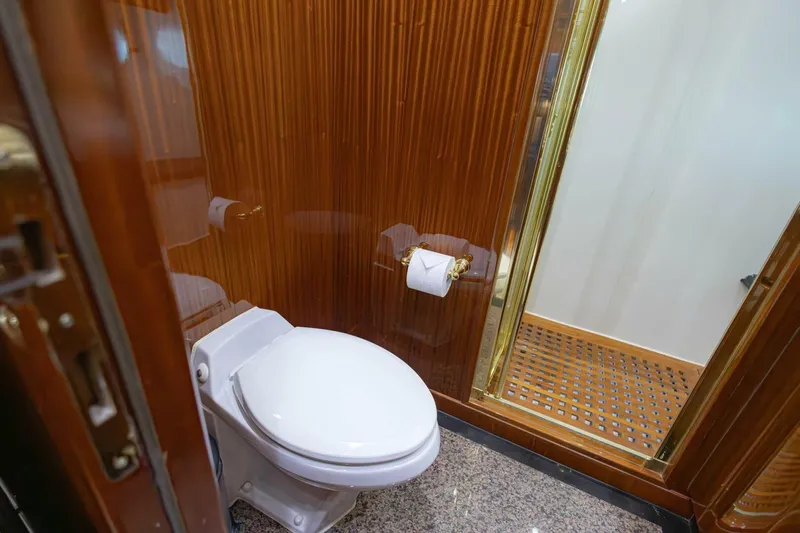 Okie Dokie Yacht Photos Pics Luxurious bathroom in 2009 Hargrave Enclosed Bridge yacht with wood paneling and modern fixtures.