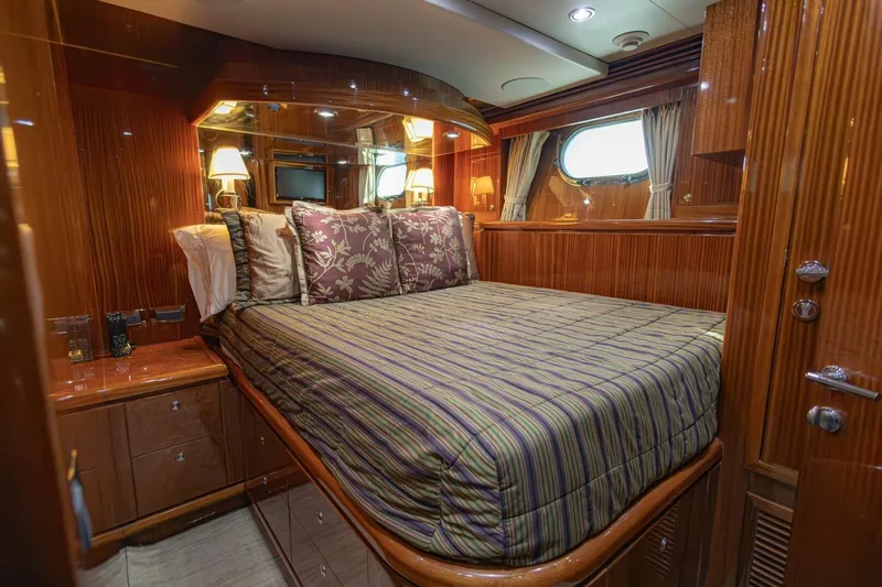 Okie Dokie Yacht Photos Pics Luxurious bedroom interior of 2009 Hargrave Enclosed Bridge yacht with elegant wood finish.