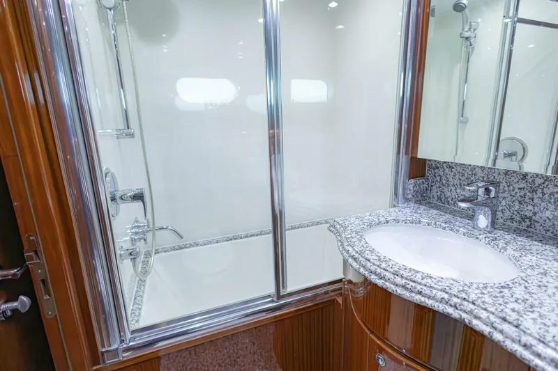 Okie Dokie Yacht Photos Pics Luxurious bathroom in 2009 Hargrave Enclosed Bridge yacht with granite countertop and glass shower.