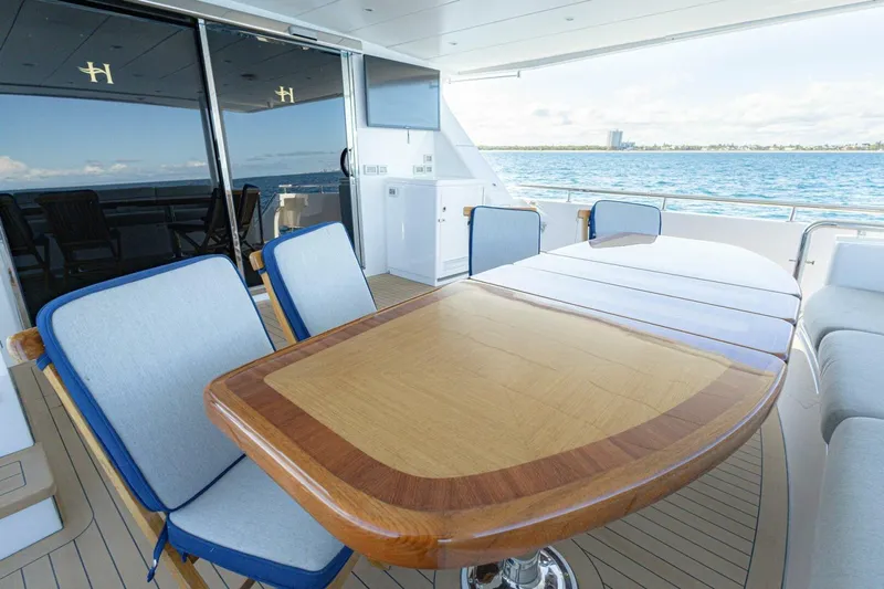 Okie Dokie Yacht Photos Pics Luxurious 2009 Hargrave Enclosed Bridge yacht deck with elegant dining area and ocean view.