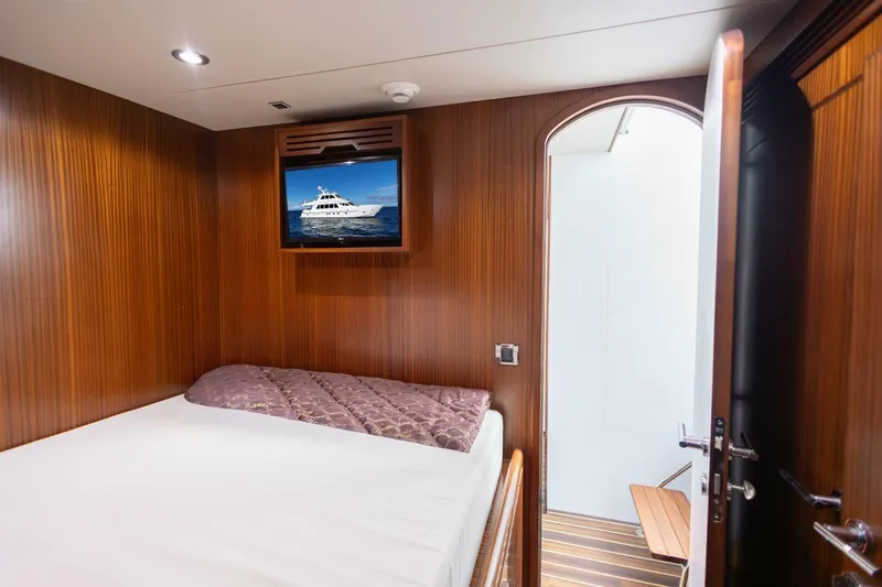 Okie Dokie Yacht Photos Pics Luxurious cabin interior of 2009 Hargrave Enclosed Bridge yacht with wood paneling and TV.