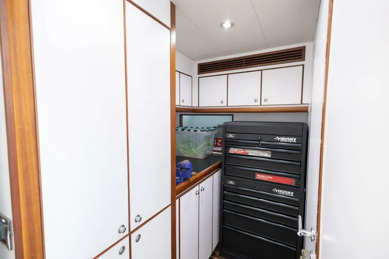 Okie Dokie Yacht Photos Pics 2009 Hargrave Enclosed Bridge yacht interior with tool storage and white cabinetry.