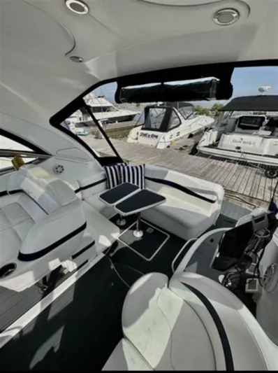  Yacht Photos Pics Interior of a 2013 Formula 37 PC yacht with white seating and striped cushions.