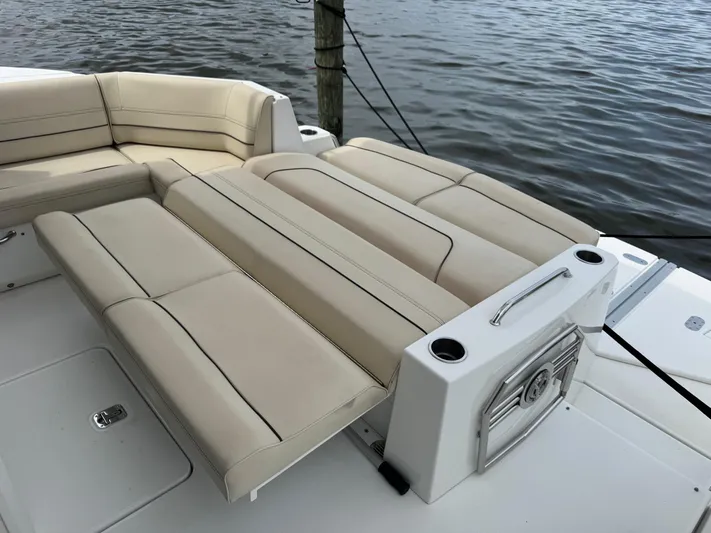  Yacht Photos Pics 2017 Cruisers Yachts 45 Cantius boat with beige seating, docked by the water.