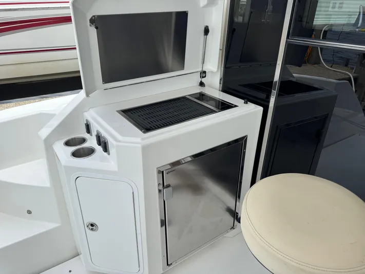  Yacht Photos Pics Outdoor kitchen area on a 2017 Cruisers Yachts 45 Cantius, featuring a grill and storage.