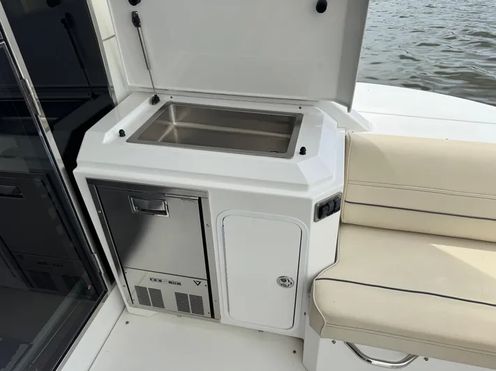  Yacht Photos Pics Outdoor kitchen area on 2017 Cruisers Yachts 45 Cantius, featuring a sink and seating.