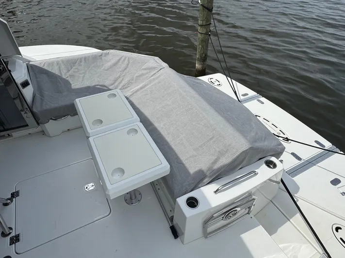  Yacht Photos Pics 2017 Cruisers Yachts 45 Cantius deck with covered seating and table, docked by water.