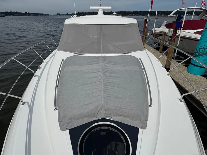  Yacht Photos Pics 2017 Cruisers Yachts 45 Cantius docked, featuring sleek design and covered deck area.