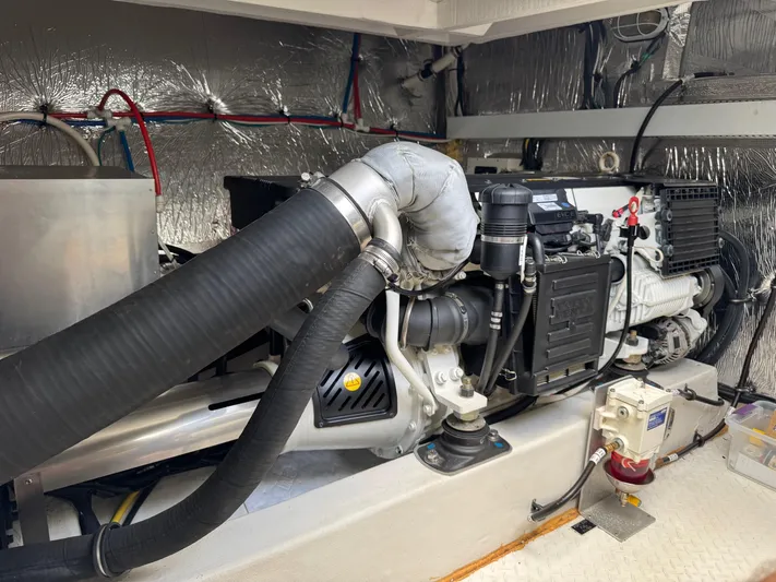  Yacht Photos Pics Engine room of 2017 Cruisers Yachts 45 Cantius, showcasing mechanical components and wiring.