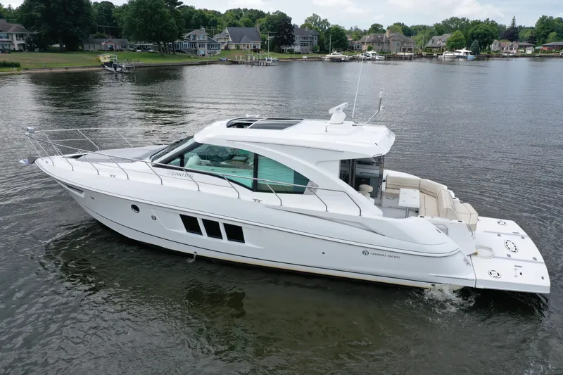 Yacht Photos Pics 2017 Cruisers Yachts 45 Cantius on a serene lake with waterfront homes.