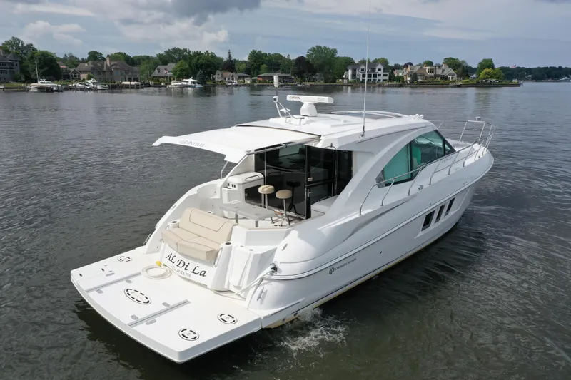 Yacht Photos Pics 2017 Cruisers Yachts 45 Cantius on serene lake with waterfront homes in background.