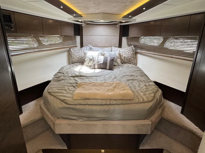  Yacht Photos Pics Luxurious bedroom interior of 2017 Cruisers Yachts 45 Cantius with elegant bedding and wood accents.
