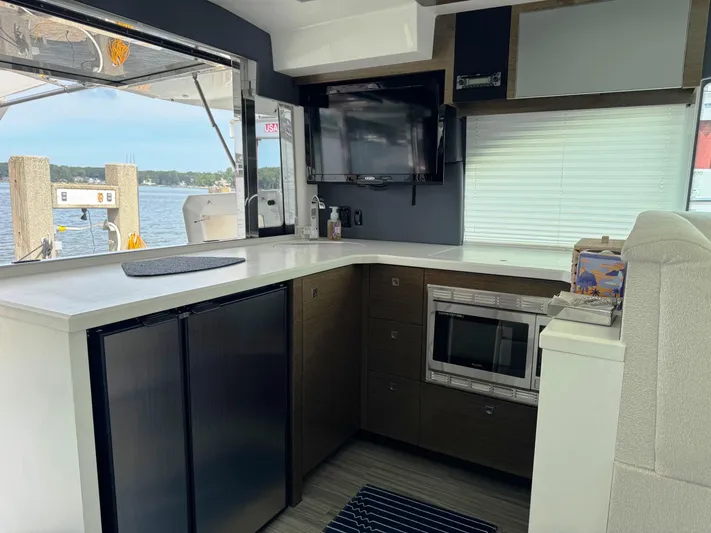  Yacht Photos Pics Interior of 2017 Cruisers Yachts 45 Cantius with modern kitchen and waterfront view.