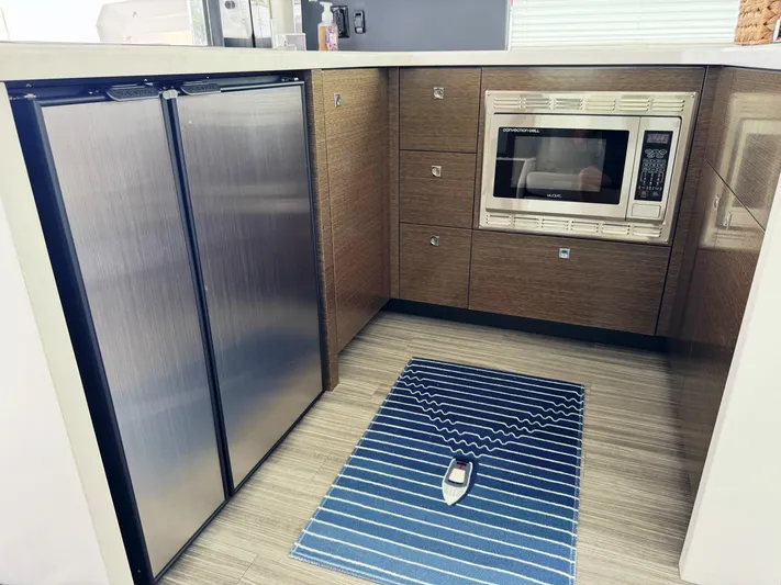  Yacht Photos Pics 2017 Cruisers Yachts 45 Cantius kitchen with stainless steel fridge and microwave.