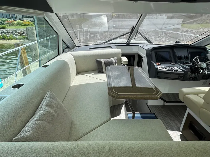  Yacht Photos Pics Luxurious interior of 2017 Cruisers Yachts 45 Cantius with plush seating and modern helm.