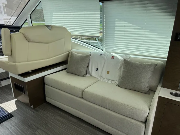  Yacht Photos Pics Luxurious interior of 2017 Cruisers Yachts 45 Cantius with beige seating and decorative pillows.