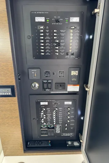  Yacht Photos Pics Electrical control panel inside 2017 Cruisers Yachts 45 Cantius, featuring switches and circuit breakers.