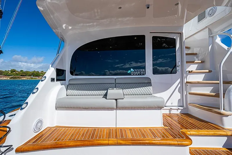 Big Stink Yacht Photos Pics 2026 Viking 54 Convertible yacht with sleek seating and wooden deck, docked by serene waters.