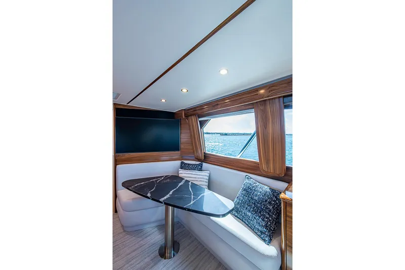 Big Stink Yacht Photos Pics Luxurious interior of 2026 Viking 54 Convertible yacht with elegant seating and ocean view.