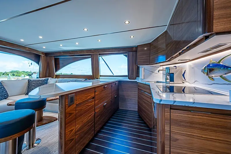 Big Stink Yacht Photos Pics Luxurious interior of 2026 Viking 54 Convertible yacht with modern kitchen and seating area.