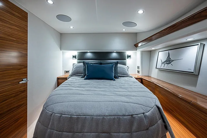 Big Stink Yacht Photos Pics Luxurious bedroom interior of 2026 Viking 54 Convertible yacht with modern design and elegant wood finishes.