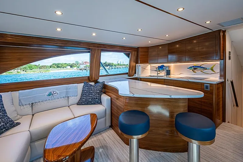 Big Stink Yacht Photos Pics Luxurious interior of 2026 Viking 54 Convertible yacht with elegant wood finishes and modern design.